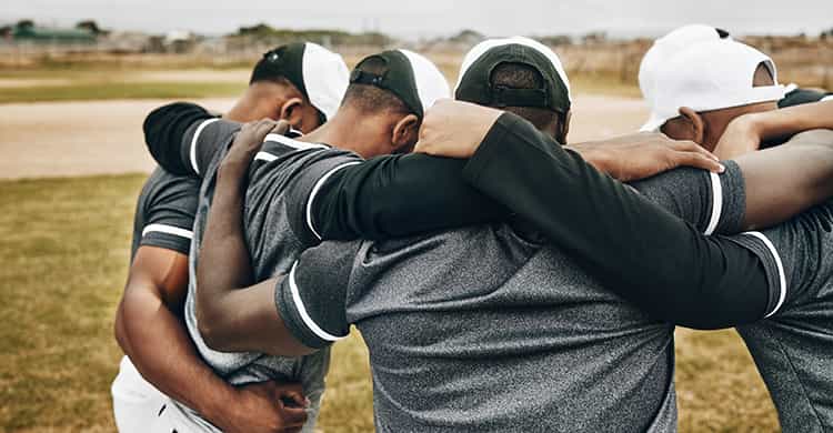 A teenage baseball player huddle
