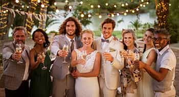 a bride and groom surrounded by their bridesmaids and groomsmen